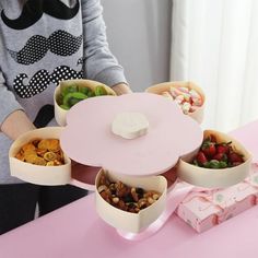 a table topped with bowls filled with different types of snacks and desserts next to a person wearing a moustache