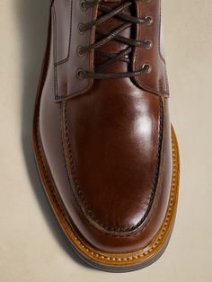 Our take on rugged luxury, this leather lace-up boot borrows its toe box construction from traditional moccasins, while quick-lace hooks at the top make for easy on-off.  Best of all, we selected a beautiful leather quality from Spain for its rich, pecan brown color.  Leather uppers and lining.  Leather, EVA, and rubber soles.  Foam footbed for comfort.  Made in Portugal.  Whole and half sizes. Brown Moc Toe Lace-up Boots With Leather Footbed, Brown Moc Toe Lace-up Boots With Stitched Sole, Brown Oiled Leather Lace-up Boots With Moc Toe, Leather Lace-up Boots With Vibram Sole Moc Toe, Brown Lace-up Boots With Moc Toe And Stitched Sole, Masculine Leather Lace-up Chukka Boots, Brown Oiled Leather Lace-up Boots, Formal Lace-up Boots With Vibram Sole, Brown Moc Toe Lace-up Boots In Calf Leather