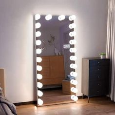 a bedroom with a large mirror and lights on the wall