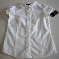 Chaps Solid White Button Down Short Sleeve Blouse Ruffle Front Youth Girl's Size Small 7 Retail $22.00 55% Cotton 45% Polyester Approved Uniform School Wear Approximate Measurements Chest 13 1/2" From Armpit To Armpit, Lying Flat Length 18 1/2" From Center Of Neck To Hem, Excluding Collar White Button Down Short Sleeve, School Blouse, Uniform School, School Wear, Button Down Short Sleeve, White Button Down, School Outfit, Short Sleeve Blouse, Kids Shirts