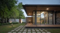 a modern house with large glass doors in the backyard