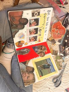 a person laying on the ground with some pictures and scissors