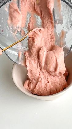 a white bowl filled with pink whipped cream