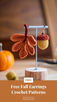 two crocheted fall leaves hanging from a hook with the text free fall earrings crochet patterns