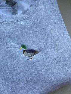 a t - shirt with a duck embroidered on the front