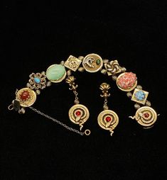 "Very little information can be found on the PIK MGK NYC jewelry makers but they did produce an exceptional art glass and serpent slide bracelet and earrings with this set; the dangle screw back earrings features the curled serpent and ruby red stone which matches one of the link on the bracelet and are 2\" long; the bracelet is 7\" long and 3/4\" wide with spring safety chain; each of the nine embossed links feature a different design and stone; the stone colors are amazing; ruby red, speckled Antique Nickel-free Bracelet, Metal Clip-on Round Jewelry, Vintage Round Clip-on Jewelry, Round Vintage Clip-on Jewelry, Unique Round Clip-on Jewelry, Ornate Nickel-free Bracelet Jewelry, Ornate Nickel-free Bracelet, Ornate Metal Jewelry Collectible, Collectible Round Costume Jewelry