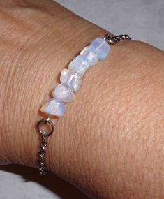 "Opalite is a manmade stone that's similar to opal or moonstone with a rainbow luster. This bracelet is 7\" long with a 1\" extension chain that can be adjusted with each link to fit. The clasp and chain are stainless steel- hypoallergenic, durable and tarnish resistant. The perfect gift for yourself, the birthday girl or even the bride!" Adjustable Opal Gemstone Bracelet, Dainty Adjustable Opal Bracelet, Adjustable Opal Gemstone Bracelets, Adjustable Opal Bracelet Gift, Adjustable Opal Bracelet For Gift, Adjustable Opal Spiritual Bracelet, Adjustable Nickel-free Opal Jewelry, Chip Bar, Bar Bracelet