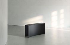 an empty room with a black table in the middle