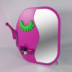 the mirror is shaped like a pink monster