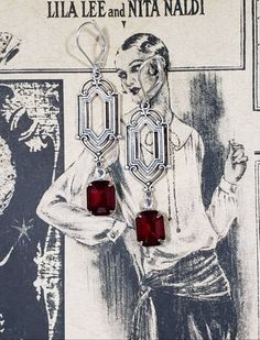 These Deco dangles are the perfect earrings for a 1920s themed wedding or party. Red vintage glass beads dangle from silver plated brass Art Deco style connectors. The silver plated brass stampings have an ornate front and a reverse side that is slightly hollow. (SEE 2nd PHOTO) These earrings are lightweight (lobe friendly) yet sturdy, free of lead and nickel. The earrings measure 2 1/4 inches long from the top of the ear wires to the bottom of the glass beads. They hang from silver plated lever Victorian Chandelier Dangle Earrings For Party, Victorian Dangle Chandelier Earrings For Parties, Victorian Style Party Chandelier Earrings, Victorian Dangle Earrings For Party, Formal Art Deco Dangle Chandelier Earrings, Art Deco Dangle Chandelier Earrings For Formal Occasions, Nickel Free Elegant Red Chandelier Earrings, Elegant Nickel-free Red Chandelier Earrings, Art Deco Chandelier Earrings For Formal Occasions