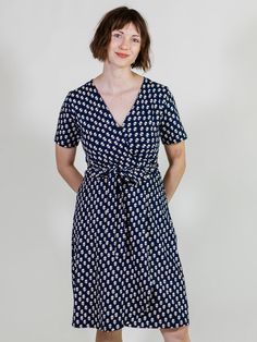 This wrap dress features a swingy skirt, fully adjustable tie, and super-soft organic cotton jersey in a simple abstract floral print. With this versatile color scheme, you can keep accessories minimal or play it up with something fun. 95% Organic Cotton 5% Spandex Jersey Full wrap Length of size M is 39" from top of bodice Made fair trade in India by one of our longstanding production partners Casual Cotton Summer Wrap Dress, Casual Cotton Wrap Dress For Summer, Casual Wrap Dress With Tie Waist, Versatile Cotton Spring Dresses, Versatile Cotton Dress For Spring, Spring Cotton Wrap Dress With Tie Waist, Casual V-neck Cotton Wrap Dress, Casual Cotton V-neck Wrap Dress, Midi-length Viscose Wrap Dress For Spring