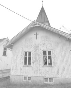 an old white church with a steeple and cross on the roof is shown in black and white