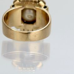 A fine French Art Deco period cocktail ring.   In 18k yellow gold.  Prong set with a large ca. 9 mm off-round, slightly baroque white pearl in a shaped setting.  Hallmarked on the band with a French 'owl' import mark (that is partially rubbed).  Simply a wonderful Deco Period ring!  Date: 20th Century  Overall Condition: It is in overall good, as-pictured, used estate condition with some very fine & light surface scratches and other signs of expected light wear consistent with age.  Fineness: Un Gold Cabochon Pearl Ring For Wedding, Gold Pearl Cabochon Ring For Wedding, Formal Gold Pearl Ring With 17 Jewels, Classic Cabochon Pearl Ring For Formal Occasions, Antique Gold Oval Pearl Ring, Classic Formal Pearl Ring With Cabochon, Victorian Gold Pearl Ring With Gemstone, Gold Victorian Pearl Ring With Gemstone, Formal Yellow Gold Pearl Ring With 17 Jewels