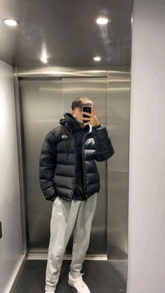 a man taking a selfie in an elevator