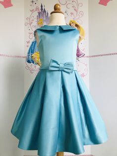 This beautiful interview dress with bow can be made special for your little girl in any size and color. Ready to ship in 3-4 weeks. Formal A-line Dress With Satin Bow, Elegant Dresses With Pleated Bodice For Dress-up, Elegant Dresses With Pleated Bodice For Formal Occasions, Elegant A-line Pageant Dress, Elegant A-line Dresses For Pageant, Satin Princess Dress For Formal Occasions, Formal Satin Princess Dress, Elegant Blue Princess Dress With Bow, Formal Princess Style Sleeveless Dress