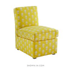 a yellow chair with white flowers on it and the words show in com written below