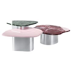 three tables with marble top and metal bases, one pink and the other white in color