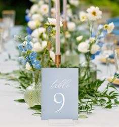 a table with flowers and candles on it