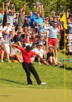 a man is playing golf in front of an audience