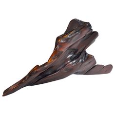 a piece of wood that is shaped like a bird's wing with an orange glow on it