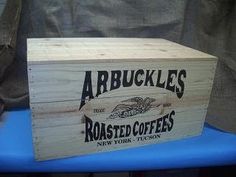 a wooden box sitting on top of a blue table