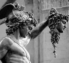 black and white photograph of a statue holding grapes