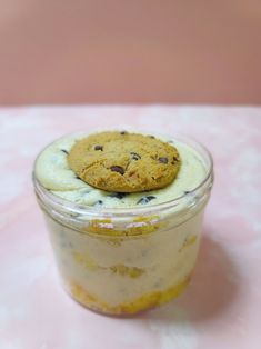 a cookie sitting on top of a dessert in a jar