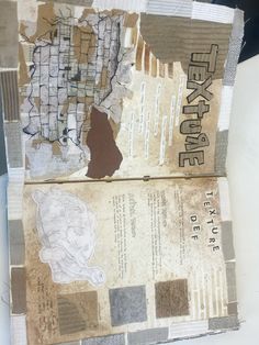 an old newspaper with some torn up papers on top of it and another piece of paper next to it