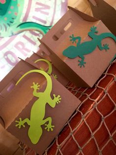 two boxes with cutouts of lizards on them