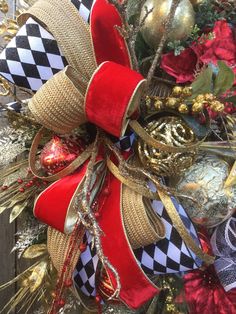 a christmas wreath with red, white and black bows