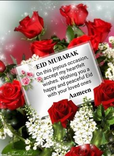 a bouquet of red roses and white flowers with a card saying, eid mubarak on this joyous occasion