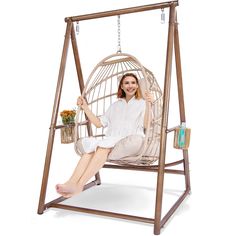 a woman is sitting in a swing chair