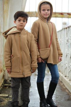 Hooded fleece jacket for boys with double-slider front zipper and two outside zipper pockets and knitted cuffs. Soft cozy fleece lined coat with warm inside fabric layer ensures the body comfort during the cold winter days. Winter coat with zipper with loose silhouette allows kids to move and play free during cold weather conditions. Our warm hooded jacket for toddler boy can be combined with casual trousers or jeans, sweaters and shirts. Hooded Fleece Jacket With Zipper For Cold Weather, Hooded Fleece Jacket With Zipper Closure For Cold Weather, Warm Brown Hooded Jacket, Warm Hooded Parka For Outdoor, Brown Hooded Fleece Jacket With Fleece Lining, Brown Hooded Fleece Jacket, Fleece-lined Hooded Jacket For Cold Weather, Hooded Parka With Zipper Closure, Winter Coat Outfits