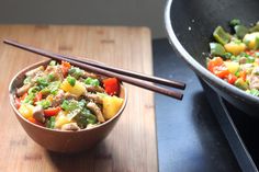 a bowl of food with chopsticks next to it