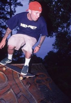 a man riding a skateboard on top of a wooden ramp