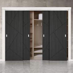 an open closet with black doors and white trim on the bottom, next to a gray wall