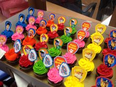 there are many cupcakes that have been decorated with cartoon characters on them,