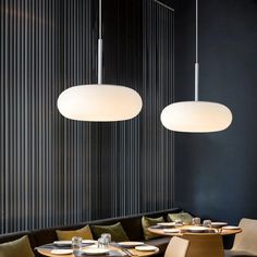 two lamps hanging over a table in a restaurant