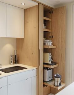 the kitchen is clean and ready to be used as a storage space for coffee makers