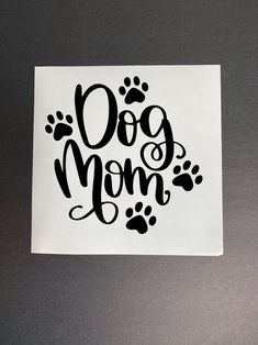 a sticker with the words dog mom written in black ink on a white paper