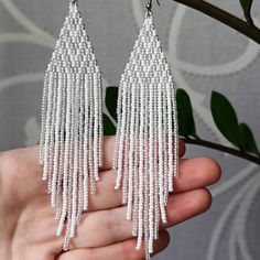 "White beaded earrings Seed bead earrings White silver chandelier earrings Shiny earrings Boho Evening earrings Length, beadwork part - 12.5 Centimeters (4.92\") Width -  3 Centimeters (1.18\") Materials: Czech glass beads Nylon Thread Silicone plugs  Stainless steel ear hooks .. ready to be given away! Contact me if you have any questions. I will be happy to answer :) Please note that due to lighting effects, monitor's brightness, contrast and other settings, there might be some slight differences in the color tone/shade of the web site's photo and the actual item. SHOP POLICY 1. If the package is damaged or your post tries to deliver you an empty package, refuse to receive it or file a claim, otherwise it can't be proven. 2. International customers are responsible for any import fees, ta Elegant Silver Beaded Chain Earrings, Silver Beaded Chain Earrings, Elegant White Beaded Chain Earrings, Silver Beaded Chain Earrings As Gift, Silver Beaded Chain Earrings For Gift, Silver Sterling Beaded Earrings With Colorful Beads, Silver Sterling Silver Earrings With Colorful Beads, Elegant White Chandelier Earrings With Colorful Beads, Silver Beaded Dangle Earrings With Faceted Beads