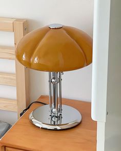 a table lamp sitting on top of a wooden desk