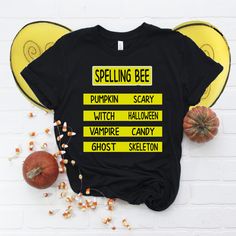 a t - shirt that says spelling bee on it next to pumpkins and candy