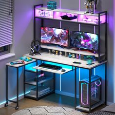 a computer desk with two monitors on it and gaming accessories in front of the monitor