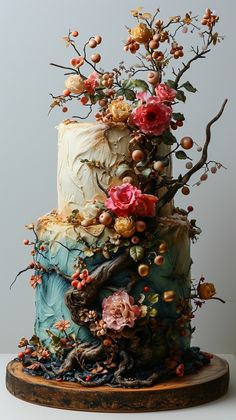 a three tiered cake decorated with flowers and branches