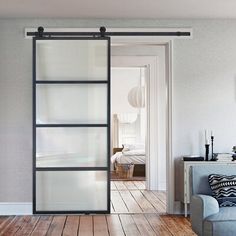 a living room with a couch and sliding glass door