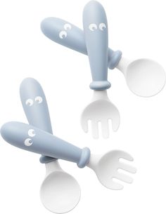 three green plastic utensils with faces drawn on them and spoons in the shape of forks