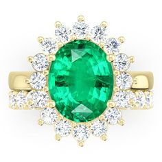 an emerald and diamond ring set in yellow gold