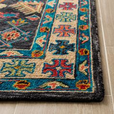 a blue rug with multicolored designs on it