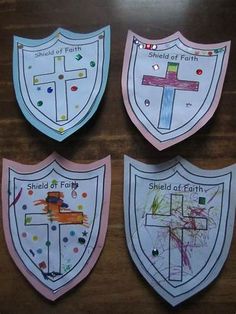 three shields with different designs on them and the words shield of faith painted on them